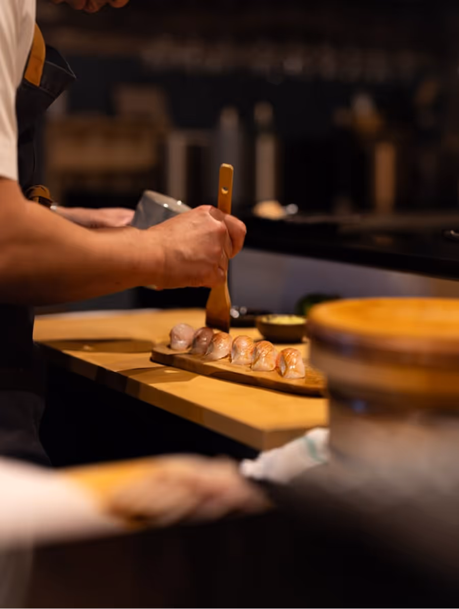 Chef brushing a nigiri course